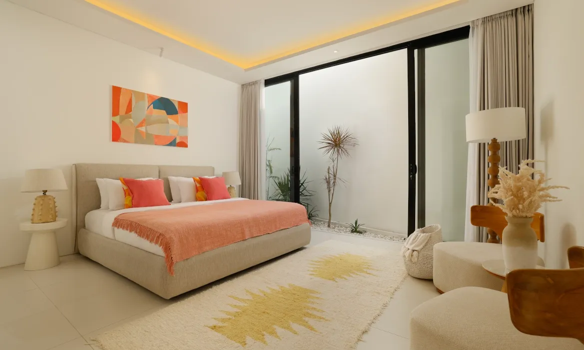 Stylish bedroom with private courtyard and modern abstract art at Kalem Canggu