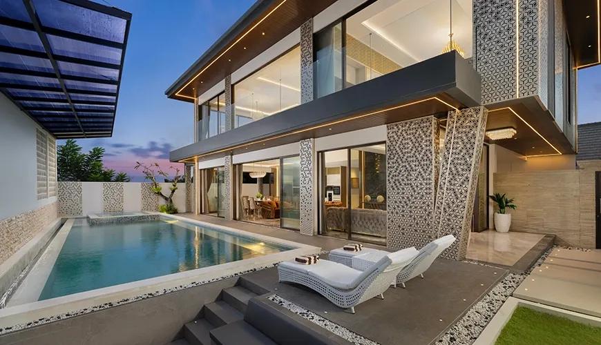 Contemporary villa exterior showing a private swimming pool with sunken seating and stylish outdoor lounge area at Kalem Uluwatu