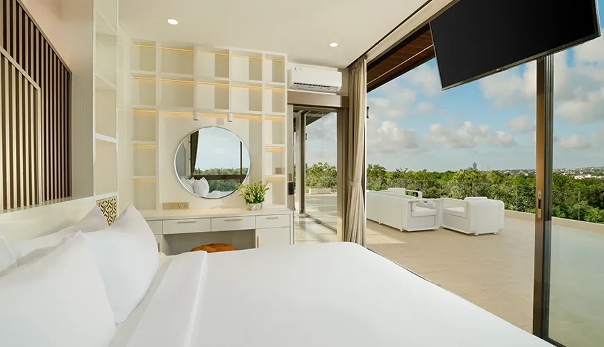 Elegant bedroom with stunning outdoor view and large television for entertainment at Kalem Uluwatu