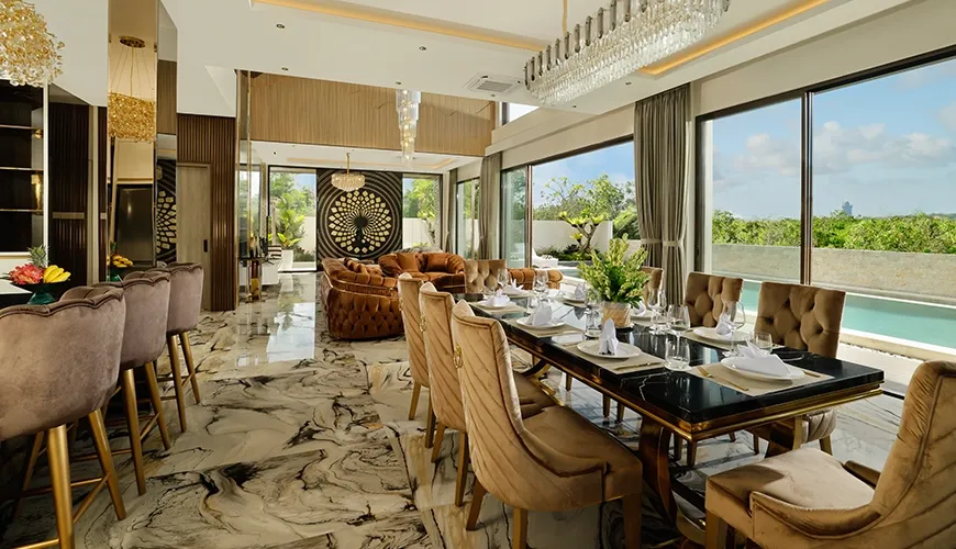 Luxury open plan living and dining area with marble floors and elegant velvet chairs at Kalem Uluwatu