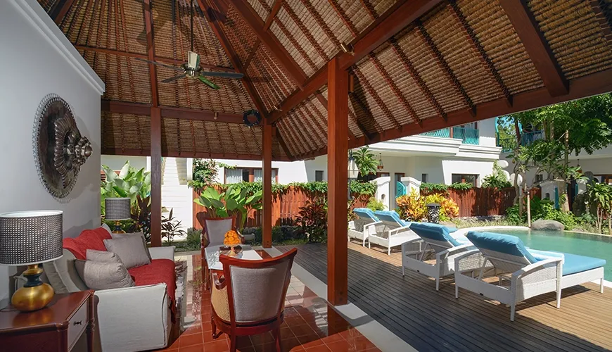 Inviting open-air lobby and lounge area with a red and wood theme located in front of the swimming pool at Kama Village 1BR