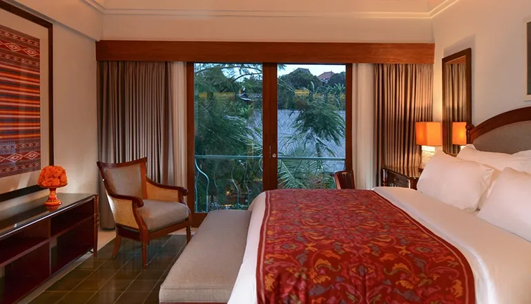 Luxurious bedroom featuring a comfortable king-size bed and a private balcony with a beautiful view at Kama Village 1BR
