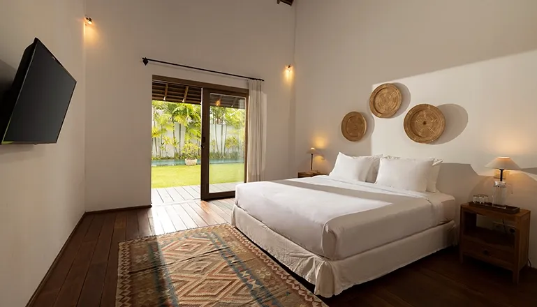 Bright bedroom king bed television and scenic garden outlook at Kuma Umalas Villa
