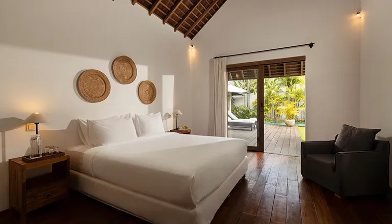 Comfortable villa bedroom king bed direct garden access at Kuma Umalas Villa