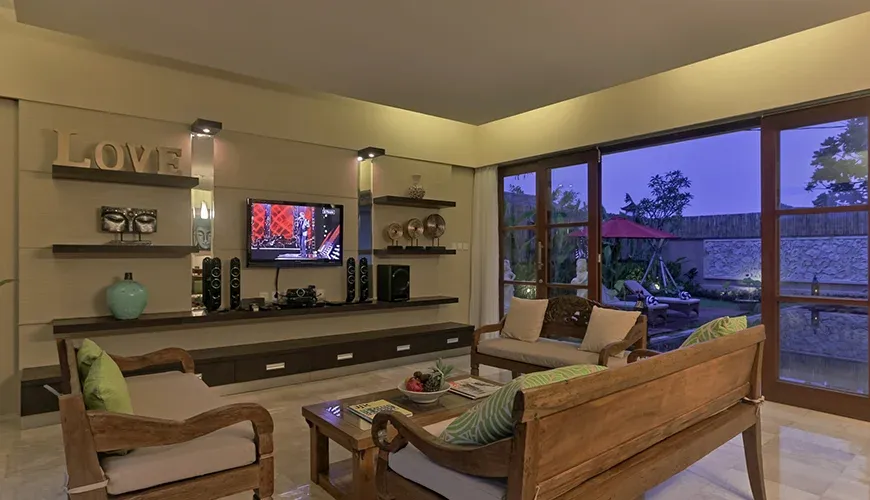 Elegant living room with a view of the pool at Kumuda Villa
