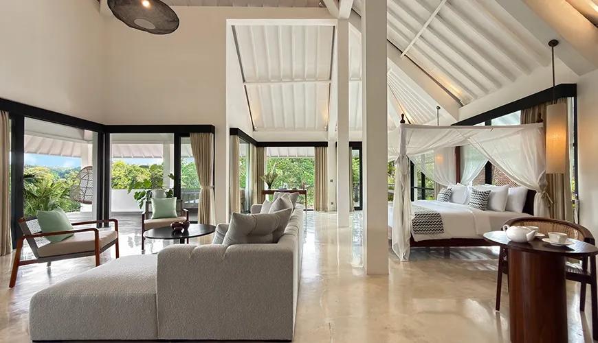 Grand Maharaja Suite villa featuring a four-poster canopy bed and spacious modern lounge seating area at Le Sunset