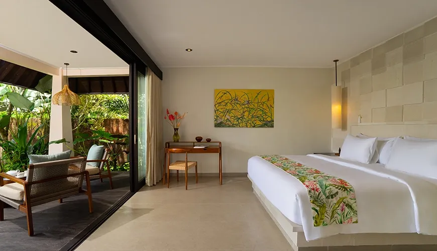 Bright modern cottage-style villa bedroom with a king size bed and lush tropical garden views at Le Sunset Villa
