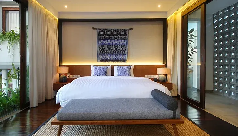 Beautiful bedroom with a comfortable bed and unique artwork at Leceni Villa