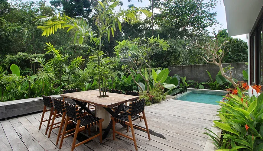 Beautiful outdoor dining area with tropical greenery at Leceni Villa
