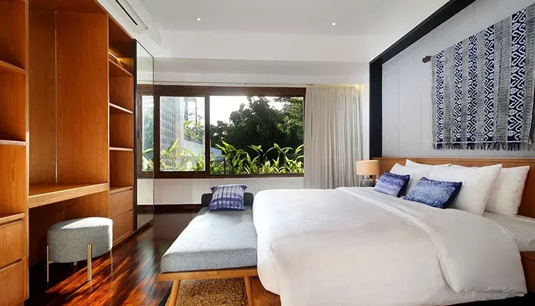 Elegant bedroom with a large bed and integrated shelving at Leceni Villa