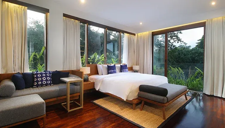 Elegant bedroom with a large bed and panoramic windows at Leceni Villa