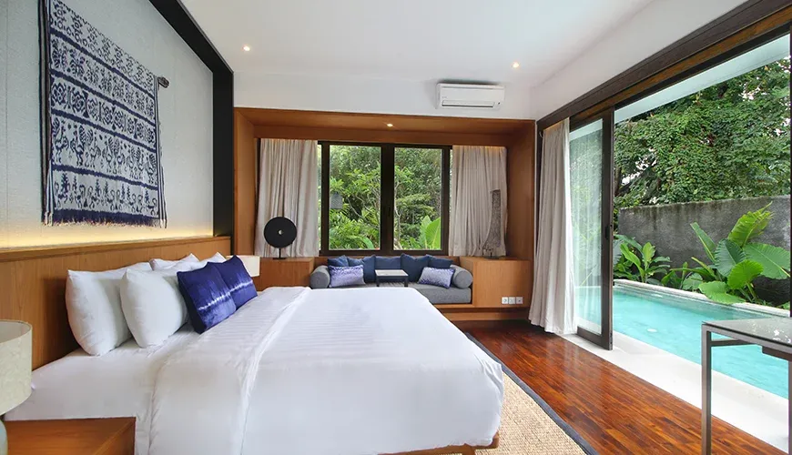 Luxurious villa bedroom with a minimalist design and pool view at Leceni Villa