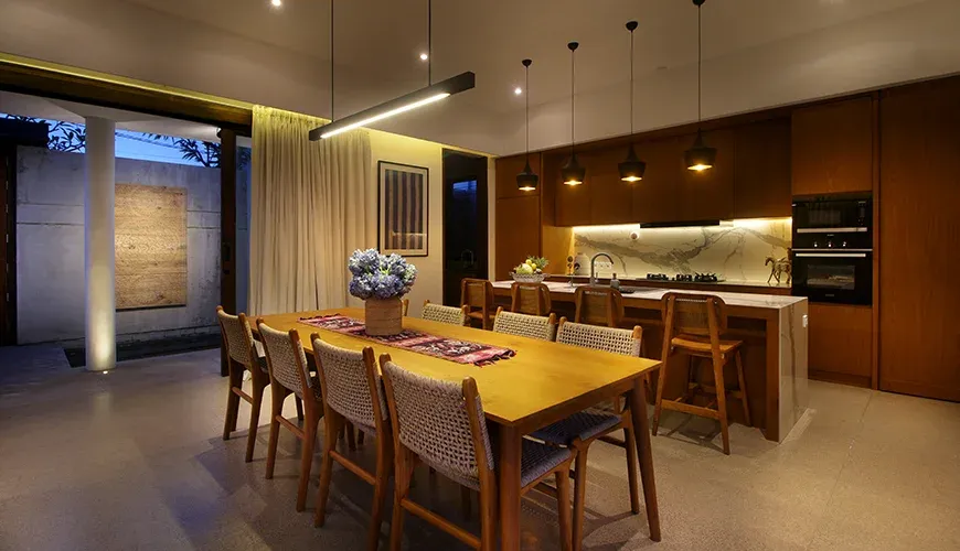 Modern dining room adjacent to a sleek open kitchen at Leceni Villa
