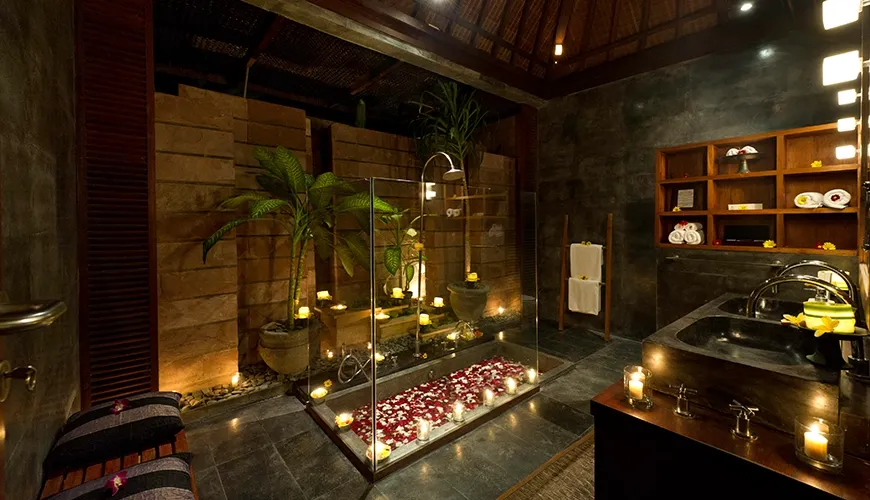 Bali villa bathroom stone walls candlelit bath at Majapahit Villa Raj