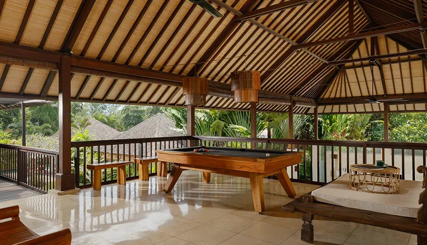 Relaxed billiards area with abundant natural light at Nelayan Villa
