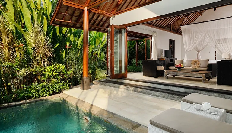 Bedroom with outdoor lounge features a private plunge pool and lush greenery at Omecure