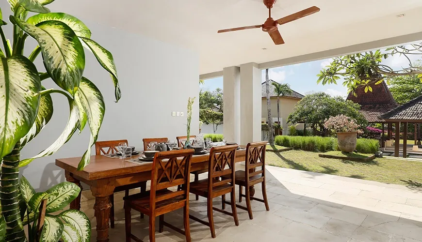 Beautiful dining space featuring a long wooden table at Omegia Canggu