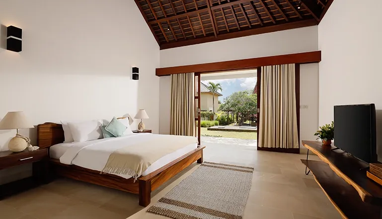 Luxurious villa bedroom with a comfortable bed and artistic accents at Omegia Canggu
