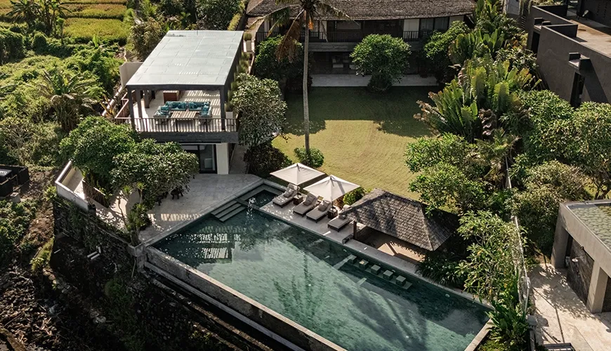 Spectacular drone view of the expansive luxury villa property featuring an infinity pool and lush tropical surroundings for an amazing vacation at Omekai Cemagi