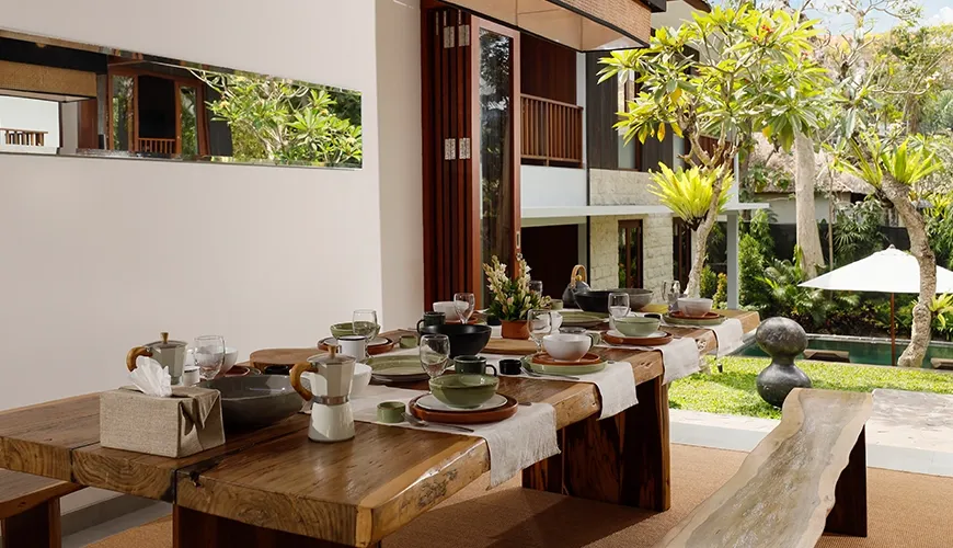 Elegant dining area with live-edge table and outdoor views at Omekali