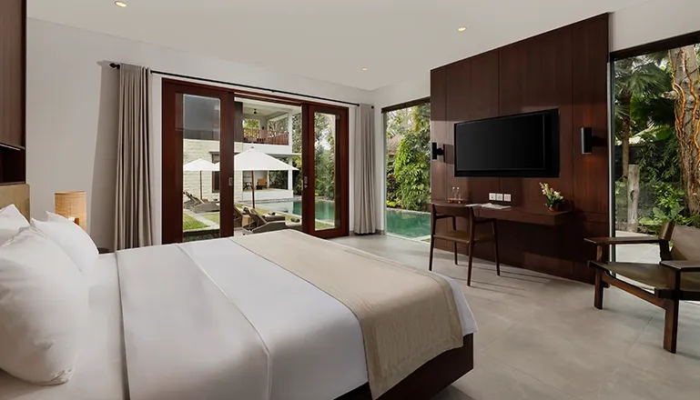 Spacious bedroom with king bed and direct pool access at Omekali