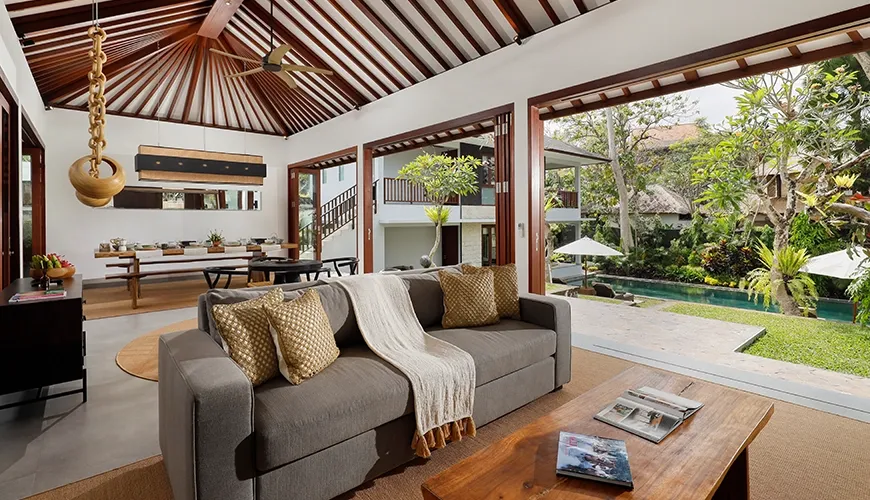 Spacious open living area with high ceilings and pool view at Omekali