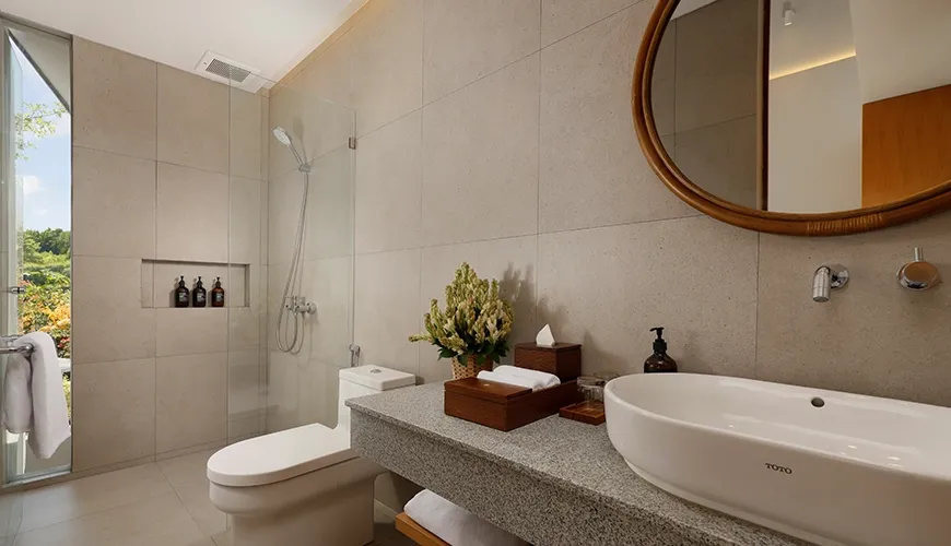 Modern bathroom with vessel sink shower and green view at Pulang Villas