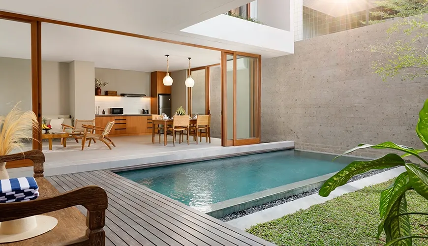 Modern pool area connecting directly to living and kitchen at Pulang Villas