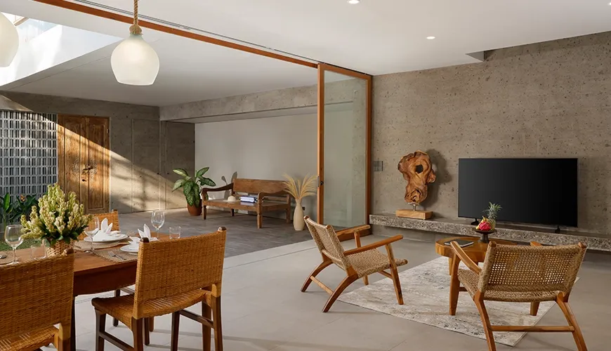 Spacious open living room with pool view and traditional decor at Pulang Villas