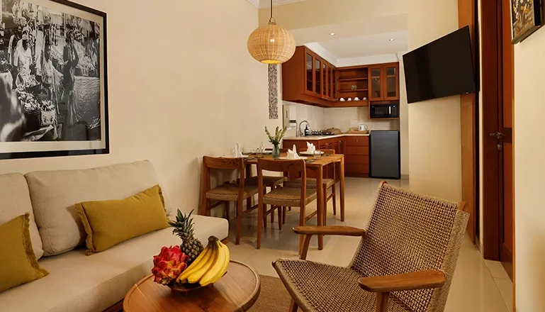 Comfortable hotel suite living area kitchenette dining table cozy chair at Sara Residence