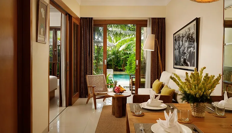 Comfortable pool suite living area dining table tropical view entrance modern at Sara Residence