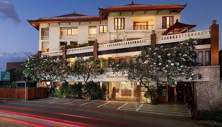 Grand hotel building traditional roof design evening lights urban setting at Sara Residence