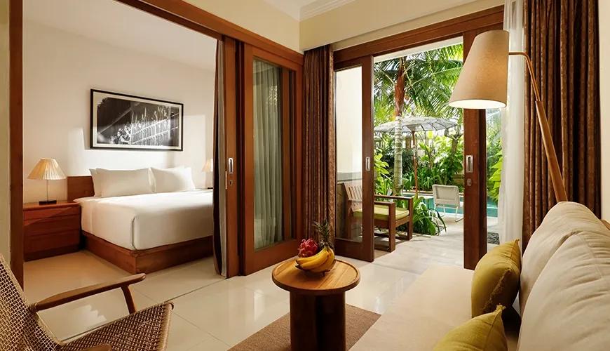 Relaxing hotel living room connects to outdoor patio tropical garden view at Sara Residence
