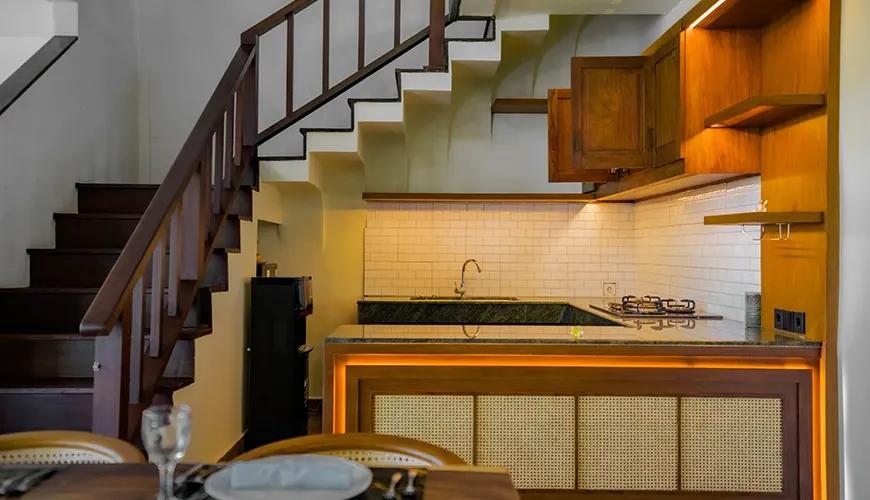 Cozy minimalist kitchen with subway tile and modern wooden cabinets at shanti estate