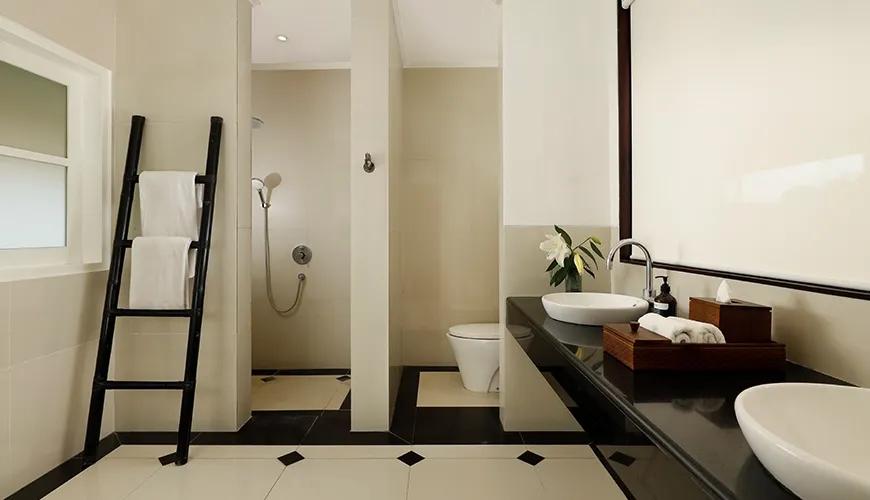 Luxury bathroom interior featuring double vessel sinks and a black and white checkered tile floor pattern at Shanti Estate