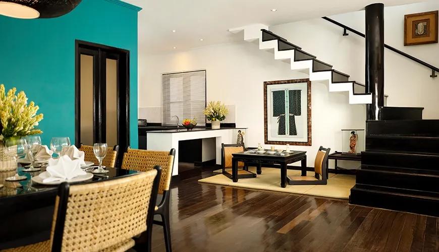 Sleek modern dining room with teal walls woven furniture and a cultural Japanese themed decor aesthetic at Shanti Estate