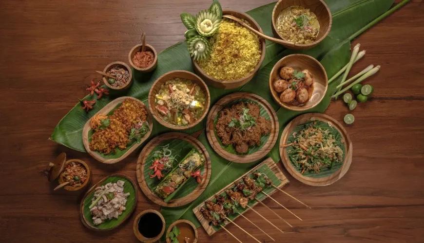Assorted authentic Indonesian cuisine served in wooden bowls on banana leaves for a luxury villa party at Shanti Residence