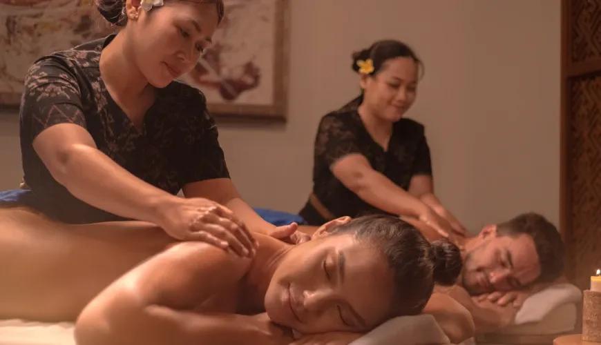 Professional therapist providing a relaxing massage to a guest in a tranquil villa spa room setting at Shanti Residence