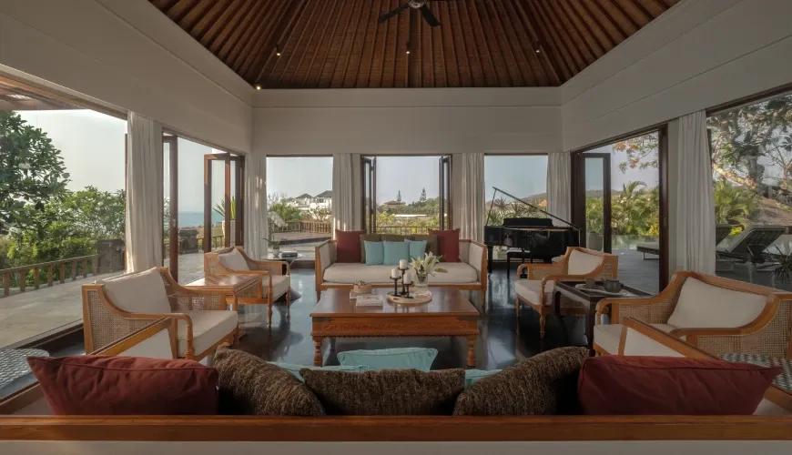 Spacious villa living area with vaulted wooden ceilings and elegant furniture overlooking a scenic tropical landscape at Shanti Residence