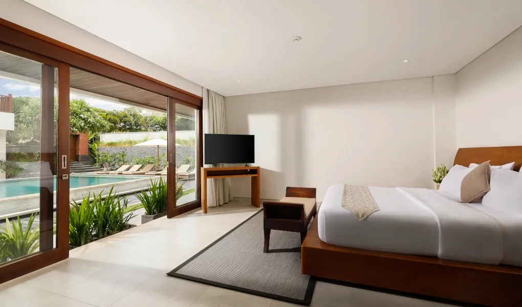 Bedroom with private pool access and a comfortable king-size bed at The Bija Villas