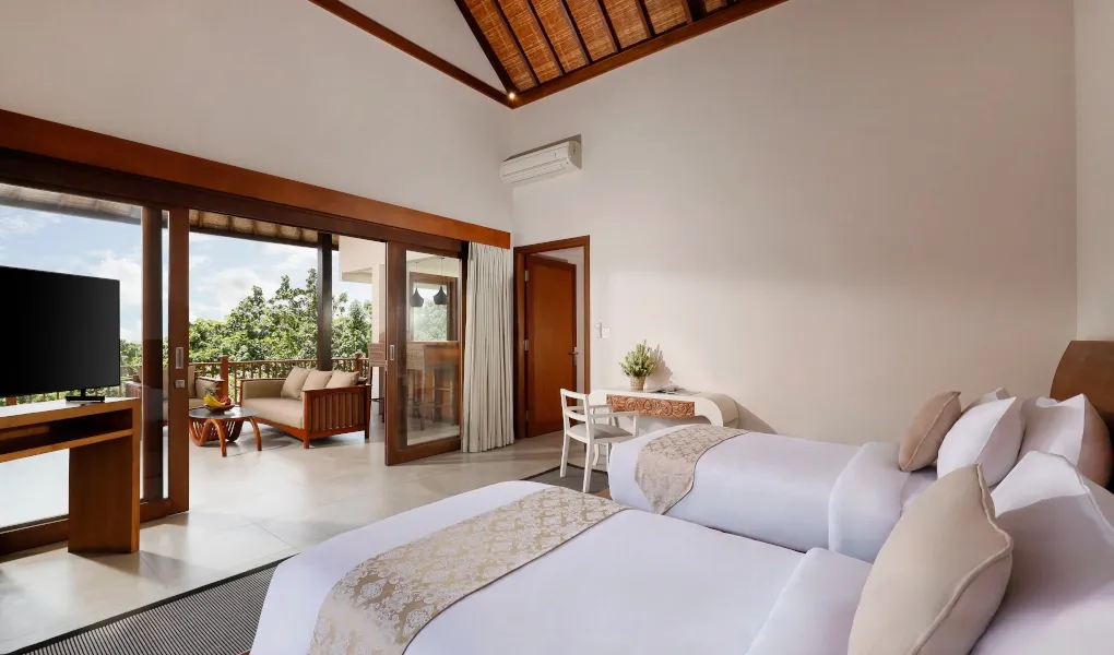 Bright twin bedroom with high ceilings and a balcony at The Bija Villas