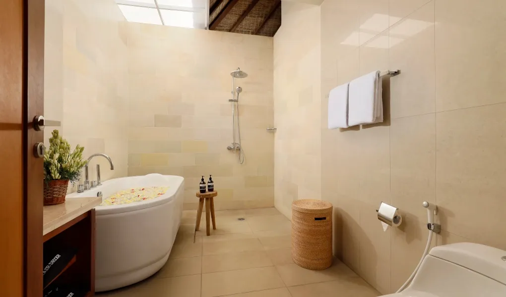 Elegant bathroom featuring a deep soaking tub and walk-in shower at The Bija Villas