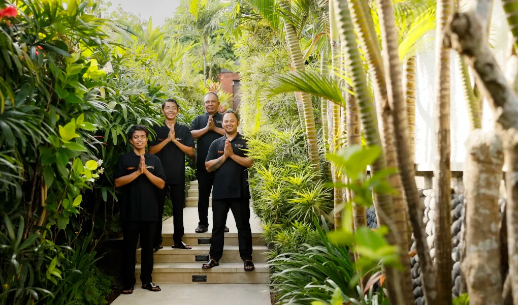 Friendly villas staff members in black uniforms standing outdoors at The Bija Villas