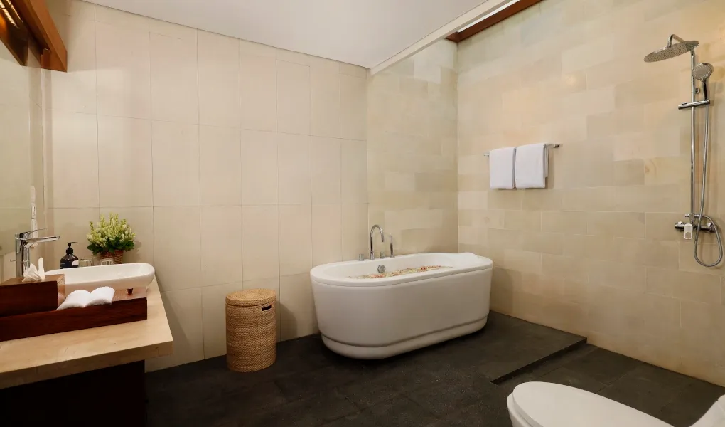 Luxurious bathroom with a free-standing bathtub and sleek stone tile at The Bija Villas