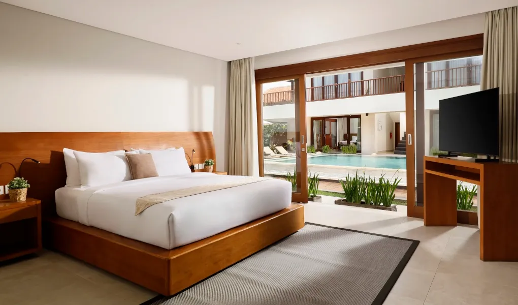 Luxurious bedroom with direct pool access through a sliding door at The Bija Villas