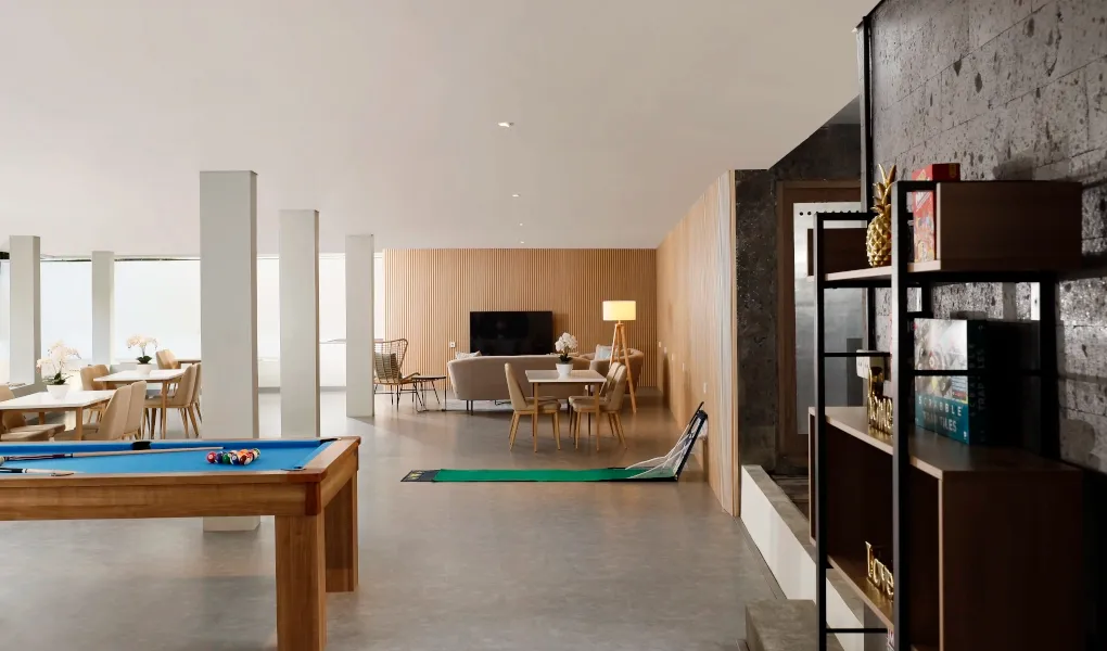 Modern entertainment room with pool table and lounge area at The Bija Villas