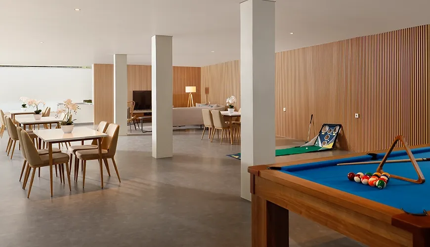 Recreational room features a billiards table, putting green, and dining area at The Bija Villas