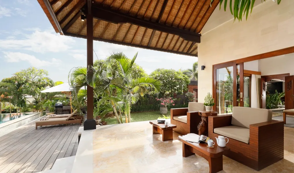 Relaxing outdoor terrace with lounge seating and a pool view at The Bija Villas