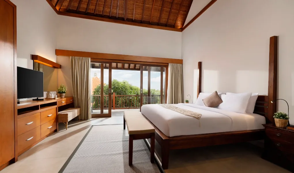 Serene bedroom with a balcony and beautiful outdoor views at The Bija Villas