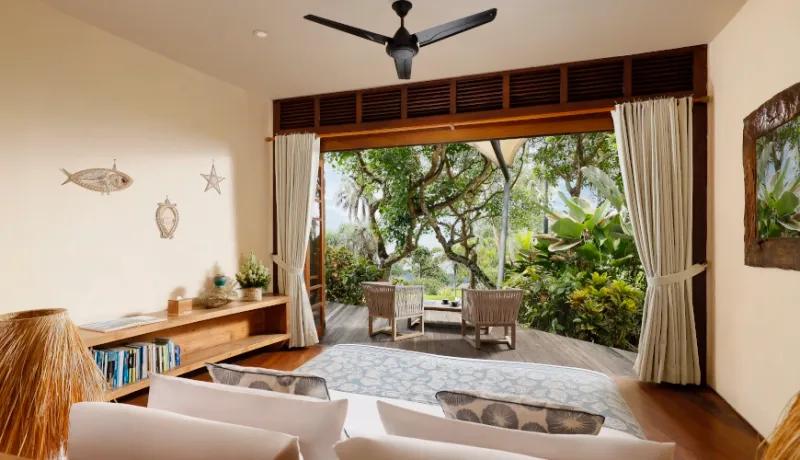 Balinese bedroom with lush jungle views and an inviting private balcony at The Cove Bali